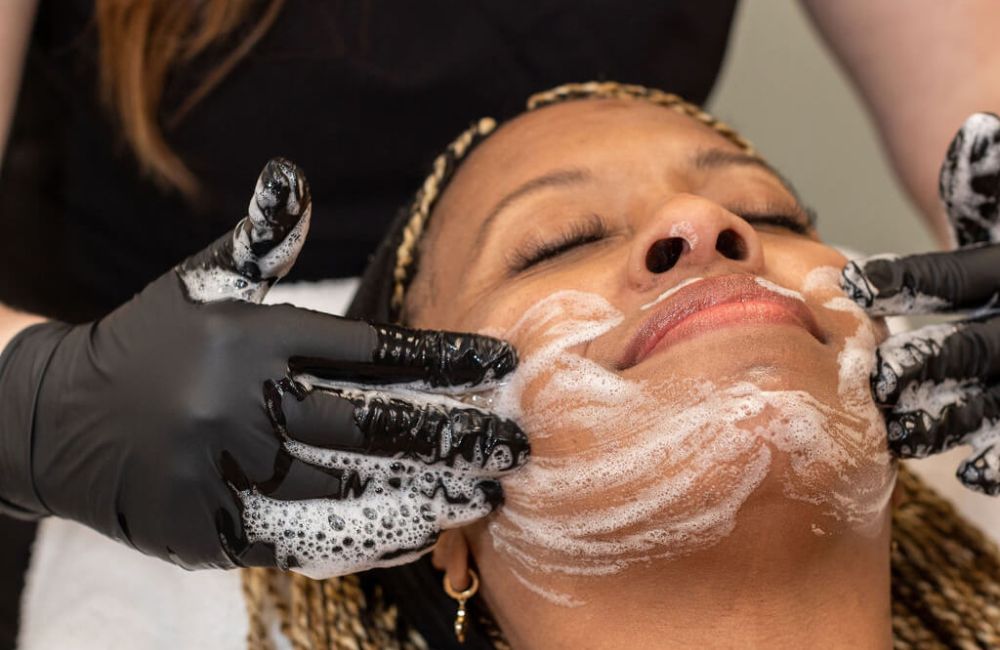 woman having a facial scrub