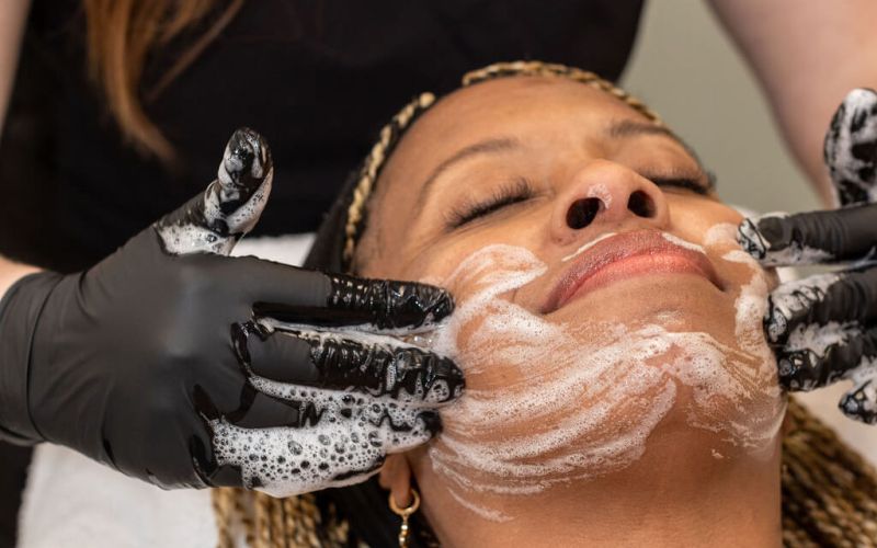 woman having a facial scrub