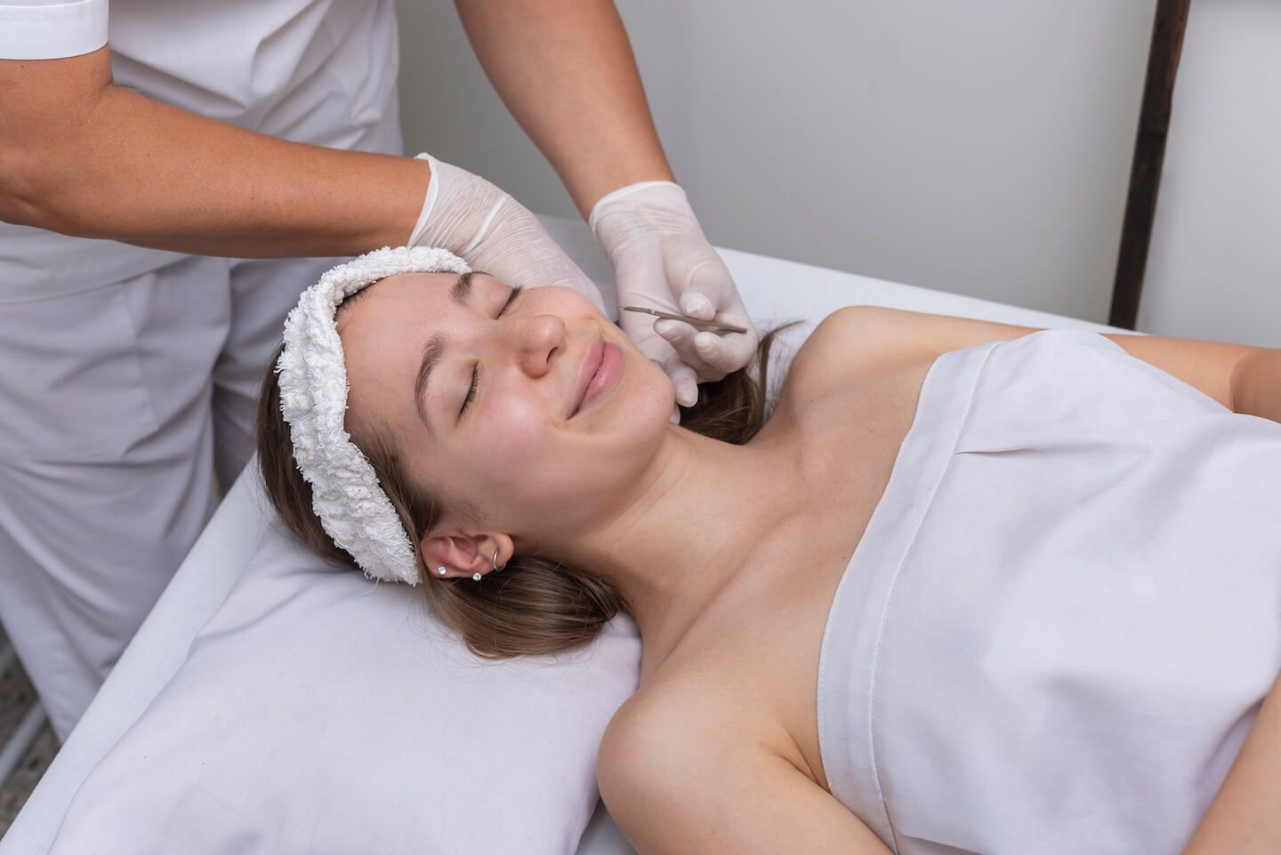 Woman getting a Dermaplaning treatment at a medical spa